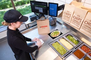 Hyphen’s Automated Makeline system, serves up a burrito bowl at a Chipotle restaurant.