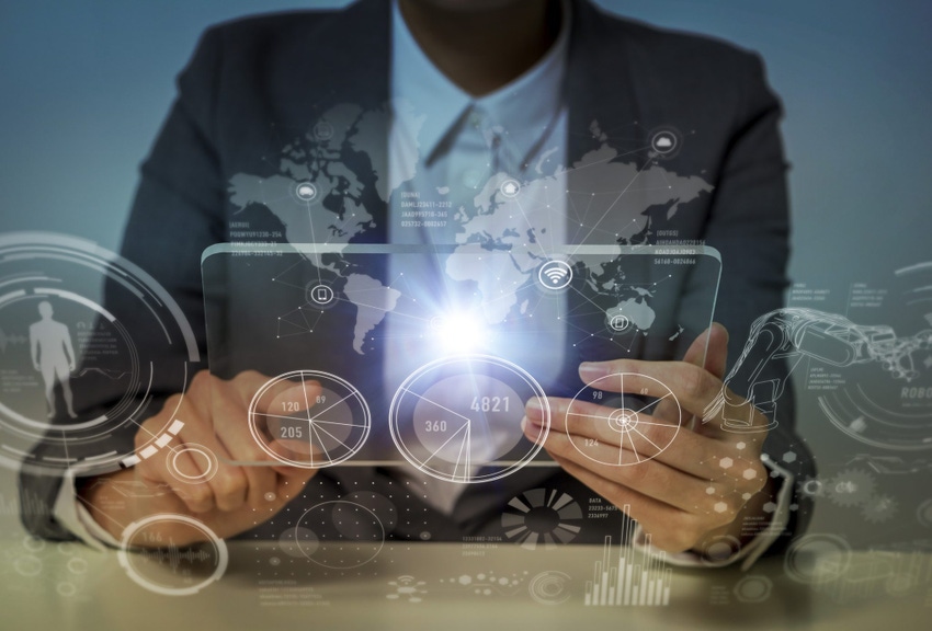 Image shows woman looking at a monitor panel with technological graphics, GUID and IoT.