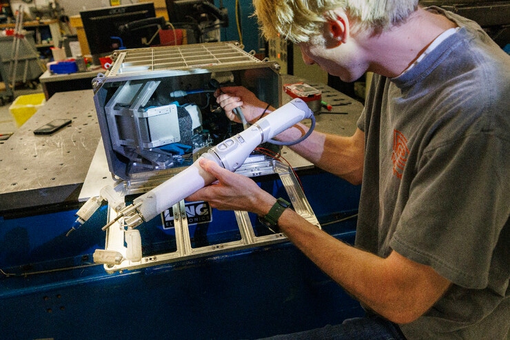 The robotic arm being loaded into its case