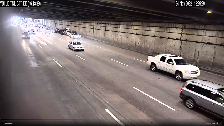 Image shows a screenshot of a video showing a Tesla multi-vehicle crash