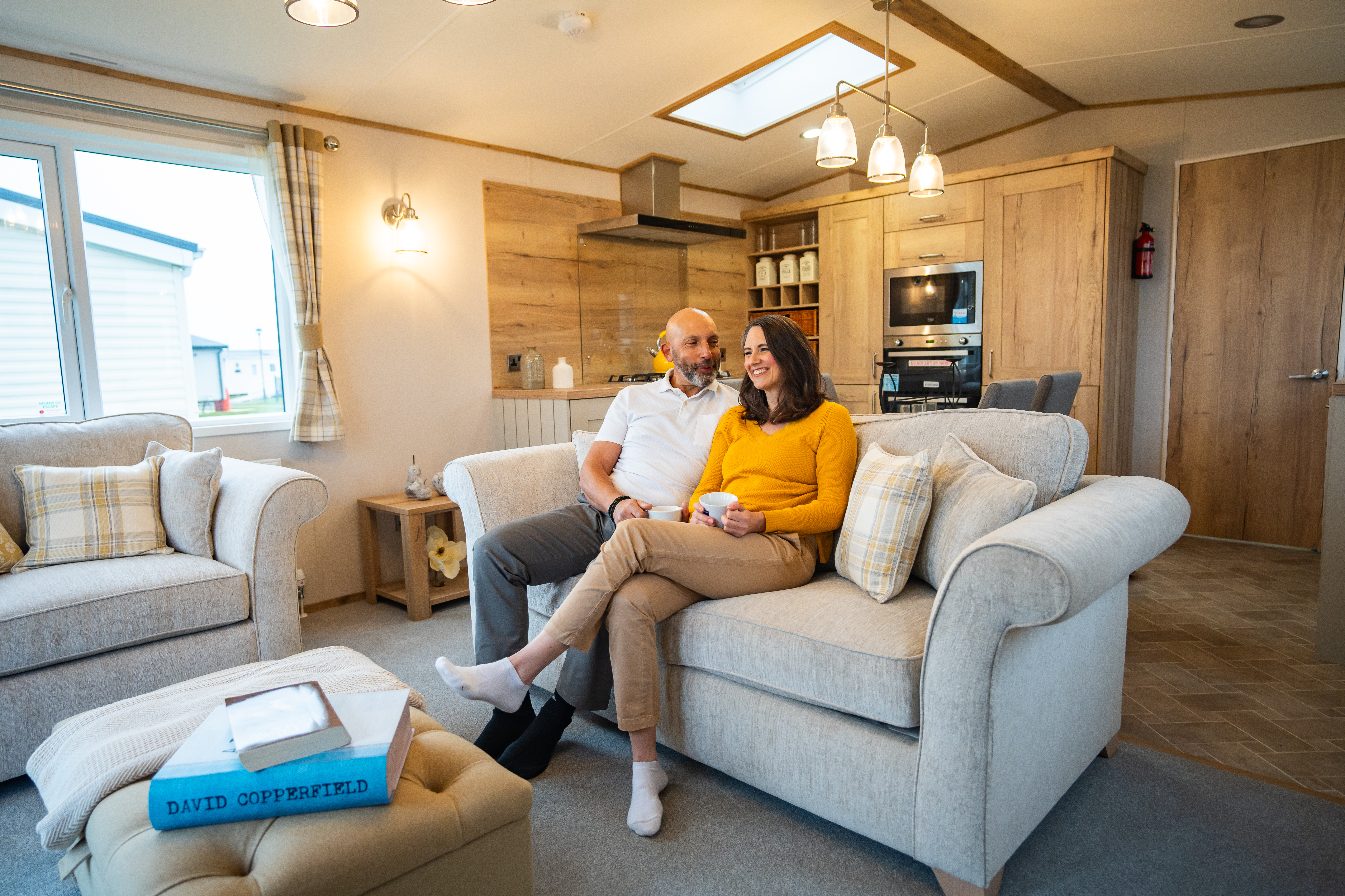 Couple sitting on a sofa inside a holiday home