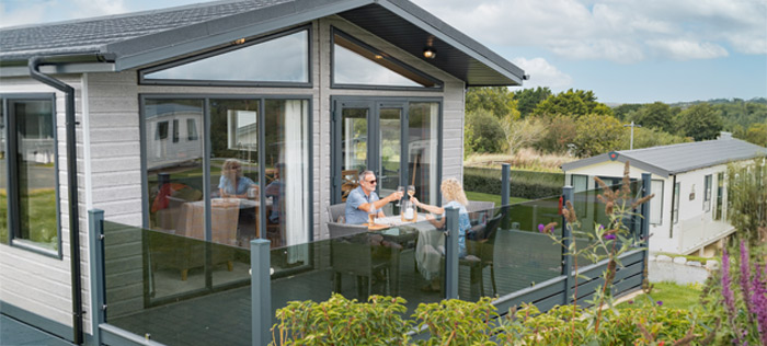 Couple relaxing on lodge decking