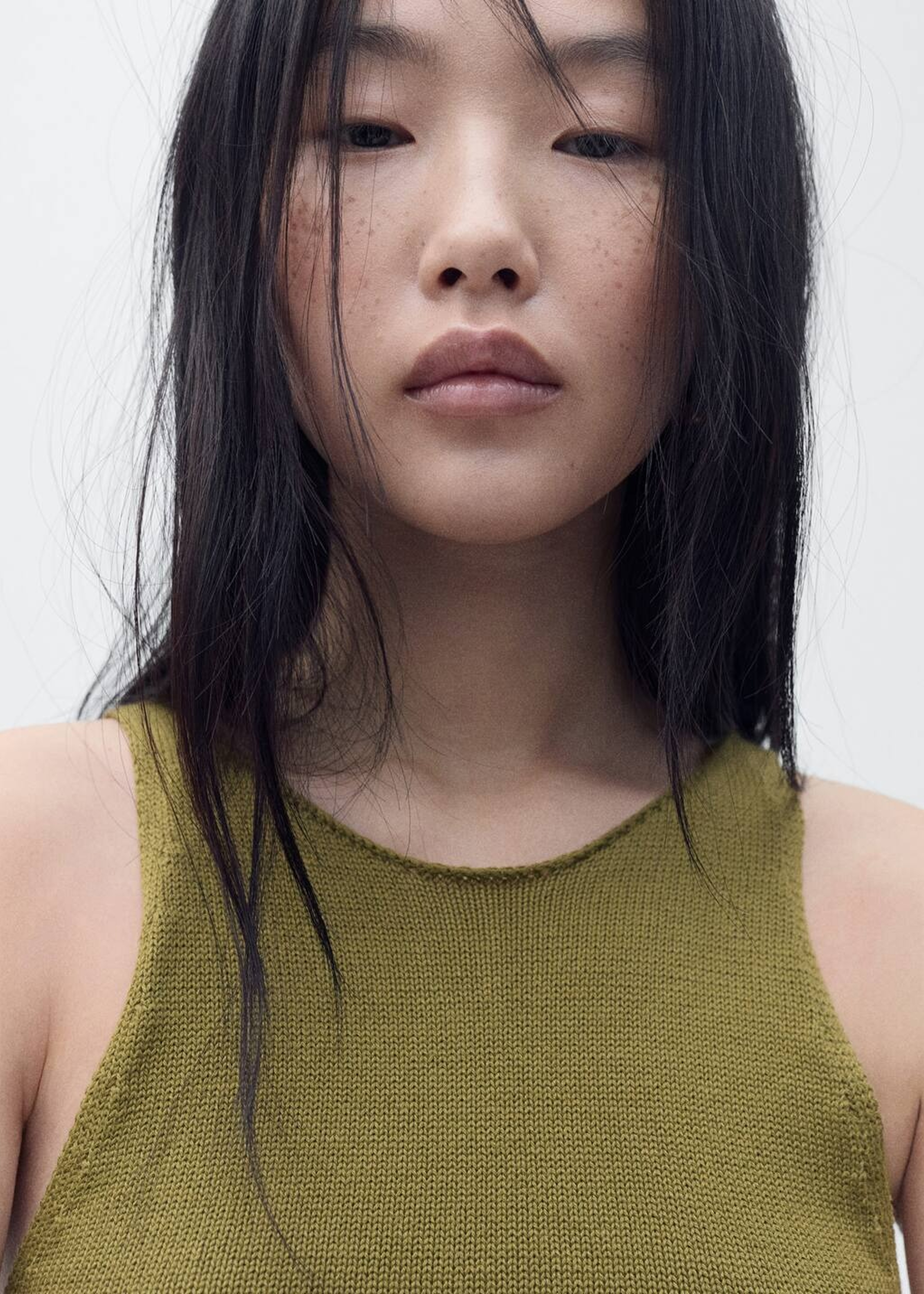 Girl wearing a shirt in autumn colours such as olive green.