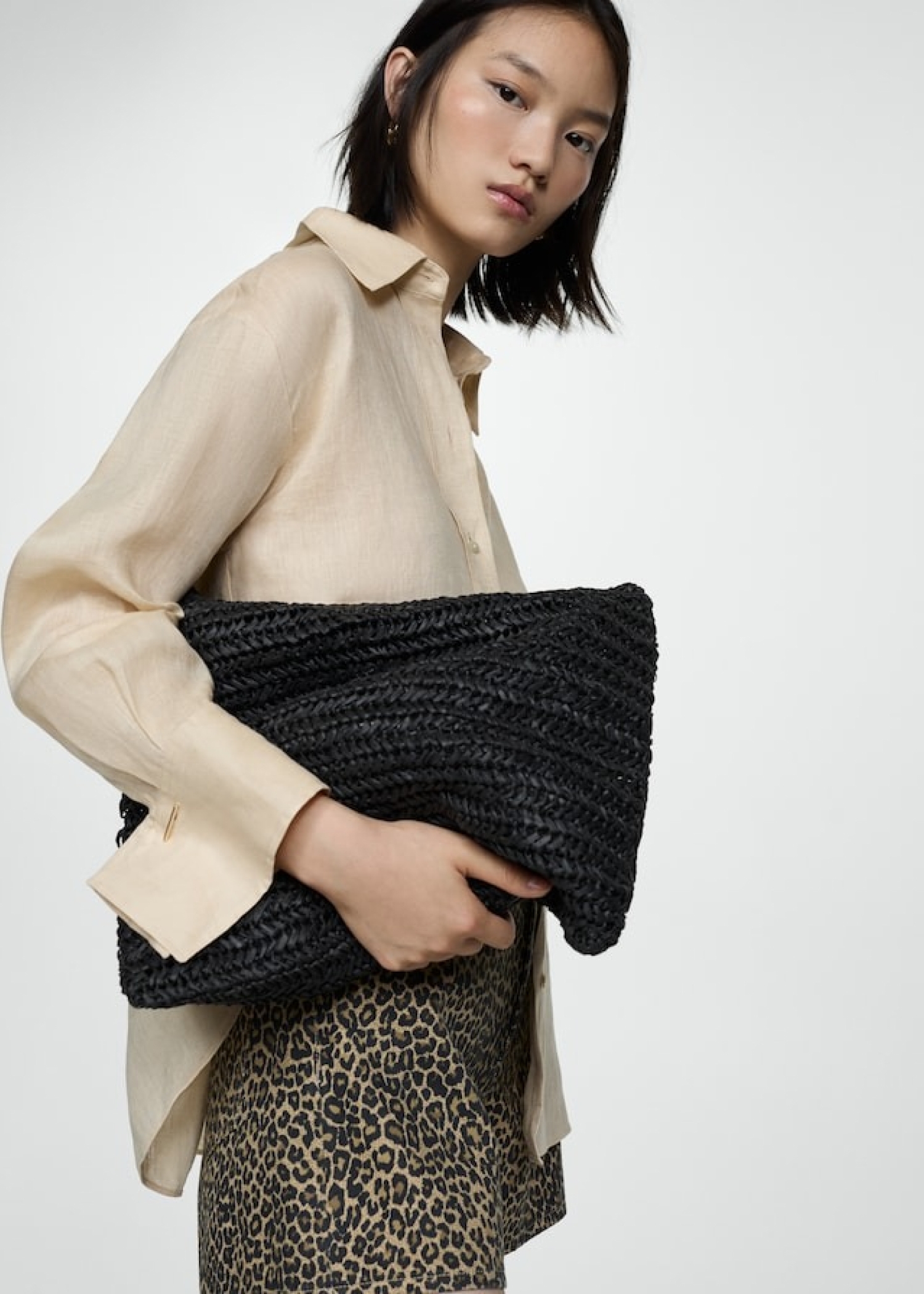 How to combine animal print with a black bag and a beige shirt.