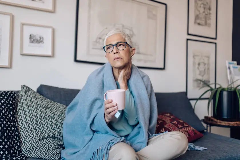 an elderly woman with a mug in her hands