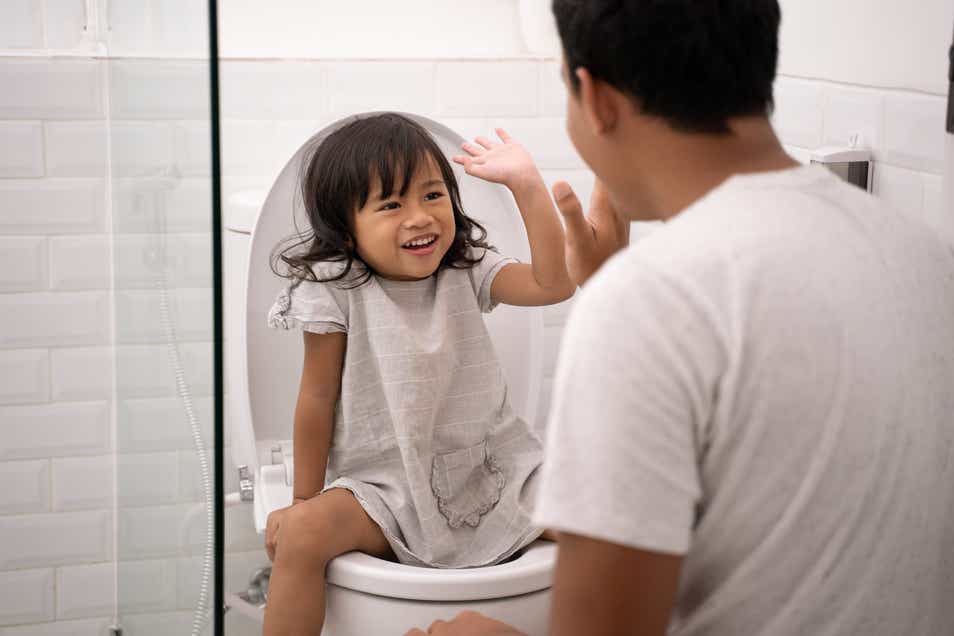 Father and daughter in the toilet