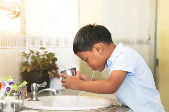 boy spits into the sink
