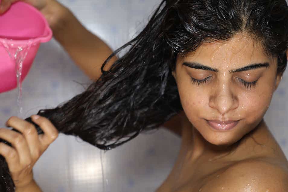 An Indian woman washing her hair 