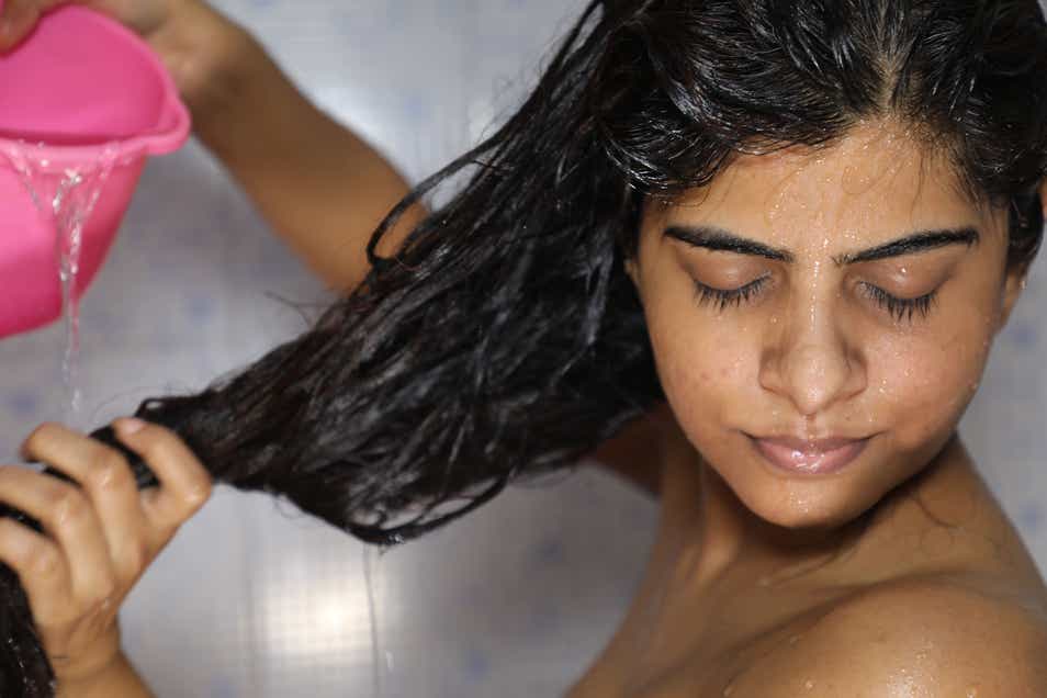 An Indian woman washing her hair