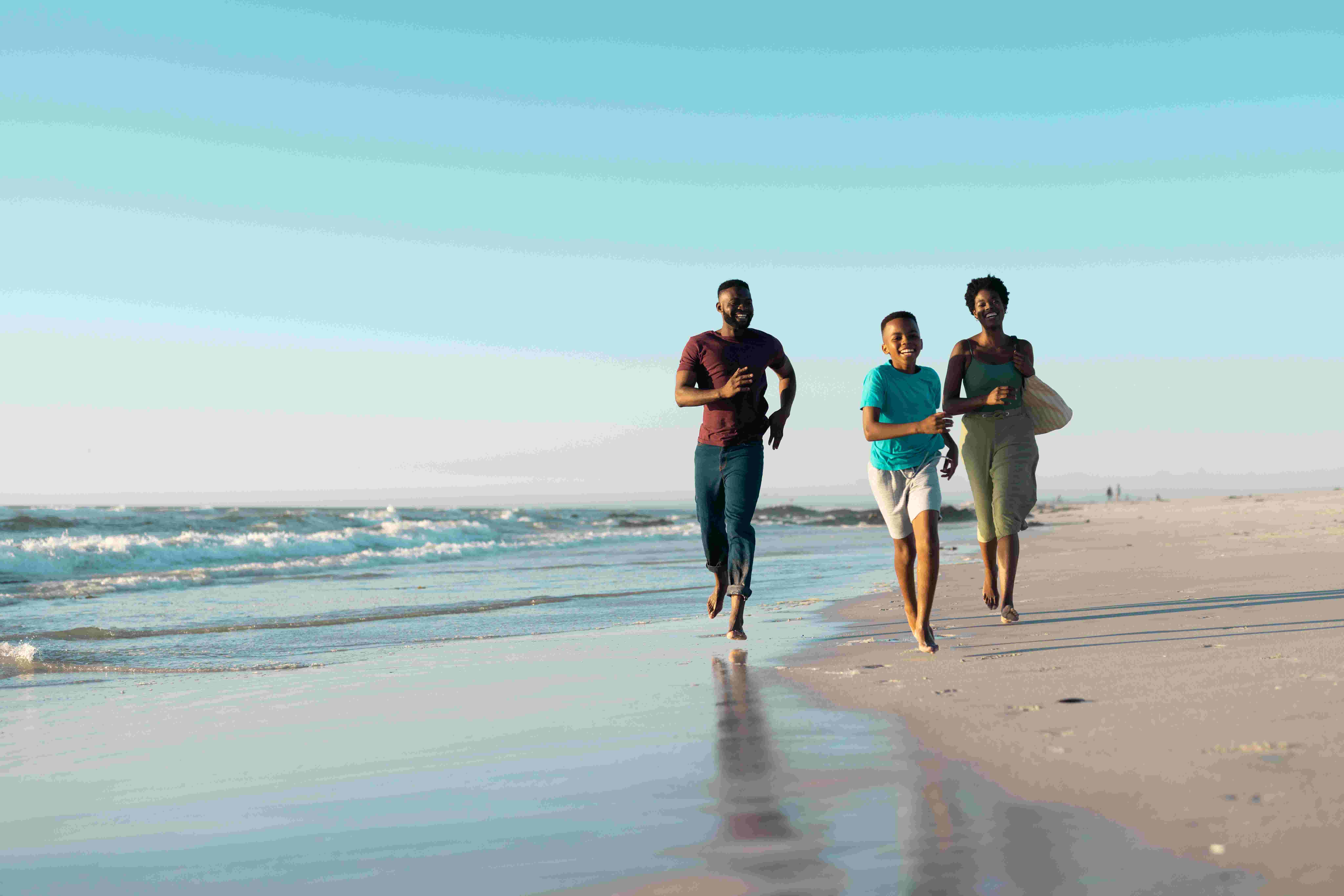 A family running on a UK beach