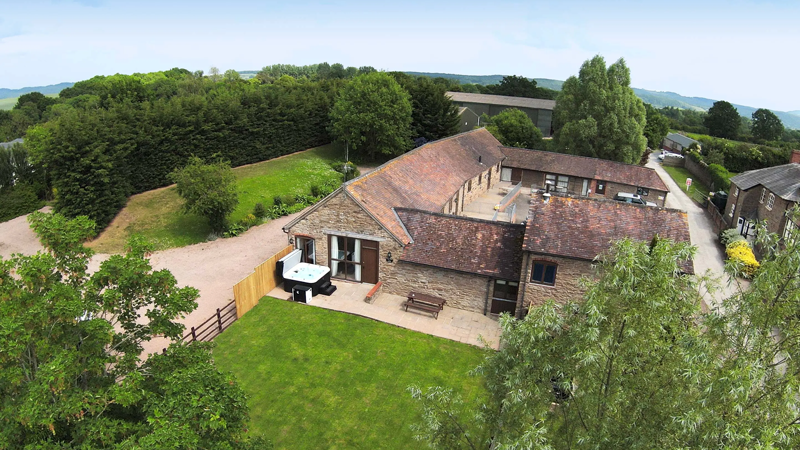 The exterior of a cottage with hot tub at Malvern View Holiday Park in Herefordshire