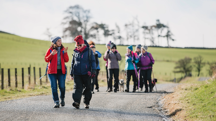 A group of people walking through the countryside
