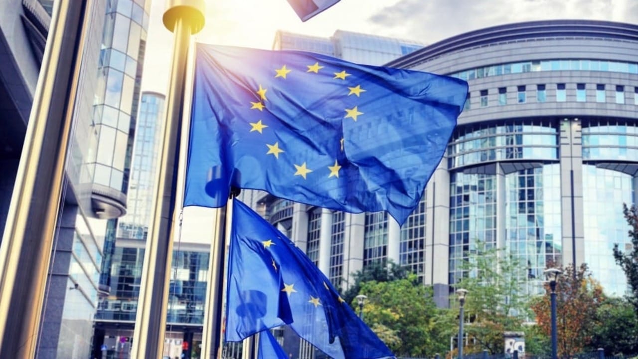 2 European Union flags flying on poles 2 European Union flags flying on poles