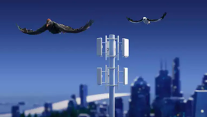 Two birds are seen flying over a mobile radio network mast