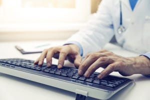 doctor typing on computer keyboard in office. online consultation
