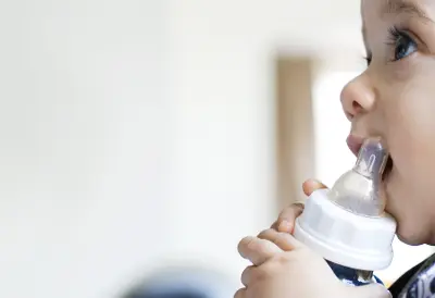 Child using an inhaler or breathing treatment device indoors