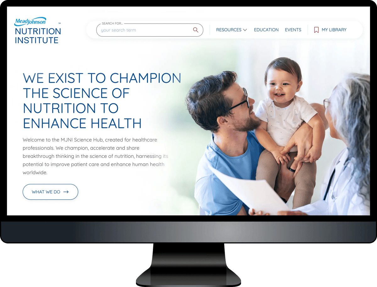 Computer monitor displaying MeadJohnson Nutrition Institute website homepage with family photo and mission statement about championing nutrition science