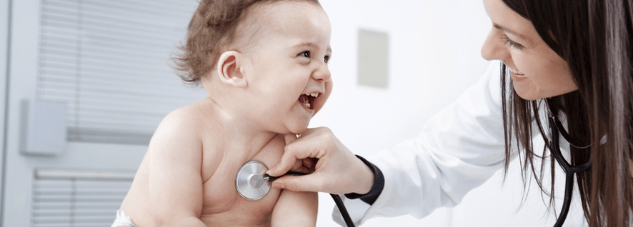 pediatrician listening to a laughing baby
