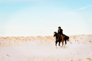Cowboy on horseback in winter