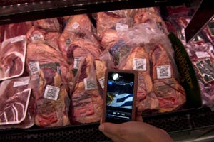 Cell phone at meat case