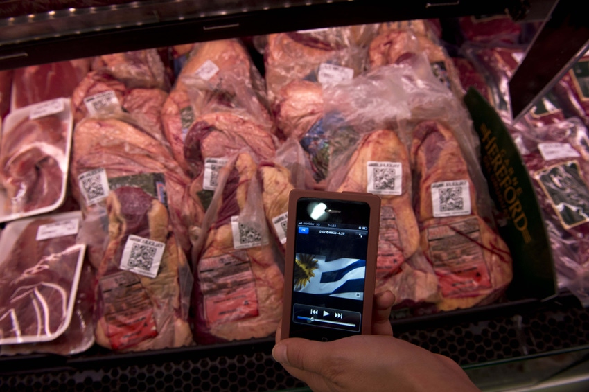 Cell phone at meat case