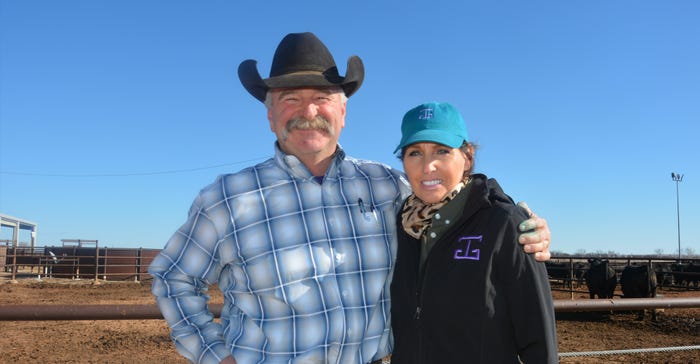 Mark and Eva Gardiner are shown in front of the confinement pens at the Henry and Nan Gardiner Marketing Center