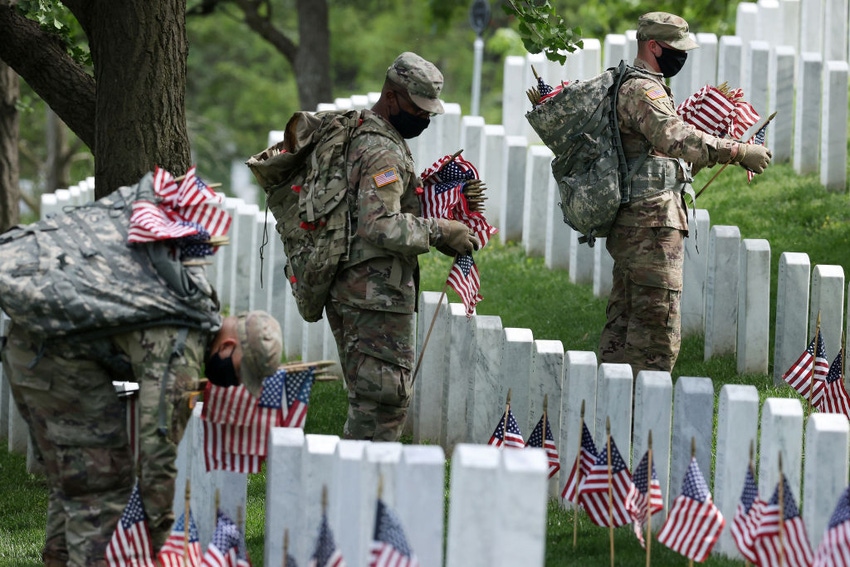Soldiers place flags at Arlington National Cemetery
