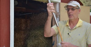 Chris Parker uses a metal hay coring probe to pull multiple cores from small square bales 