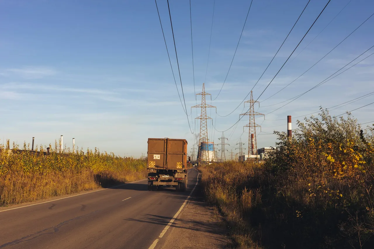 A truck driving beneath power lines A truck driving beneath power lines