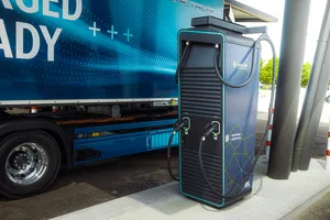 Electric heavy truck in front of a charging station. Electric heavy truck in front of a charging station.