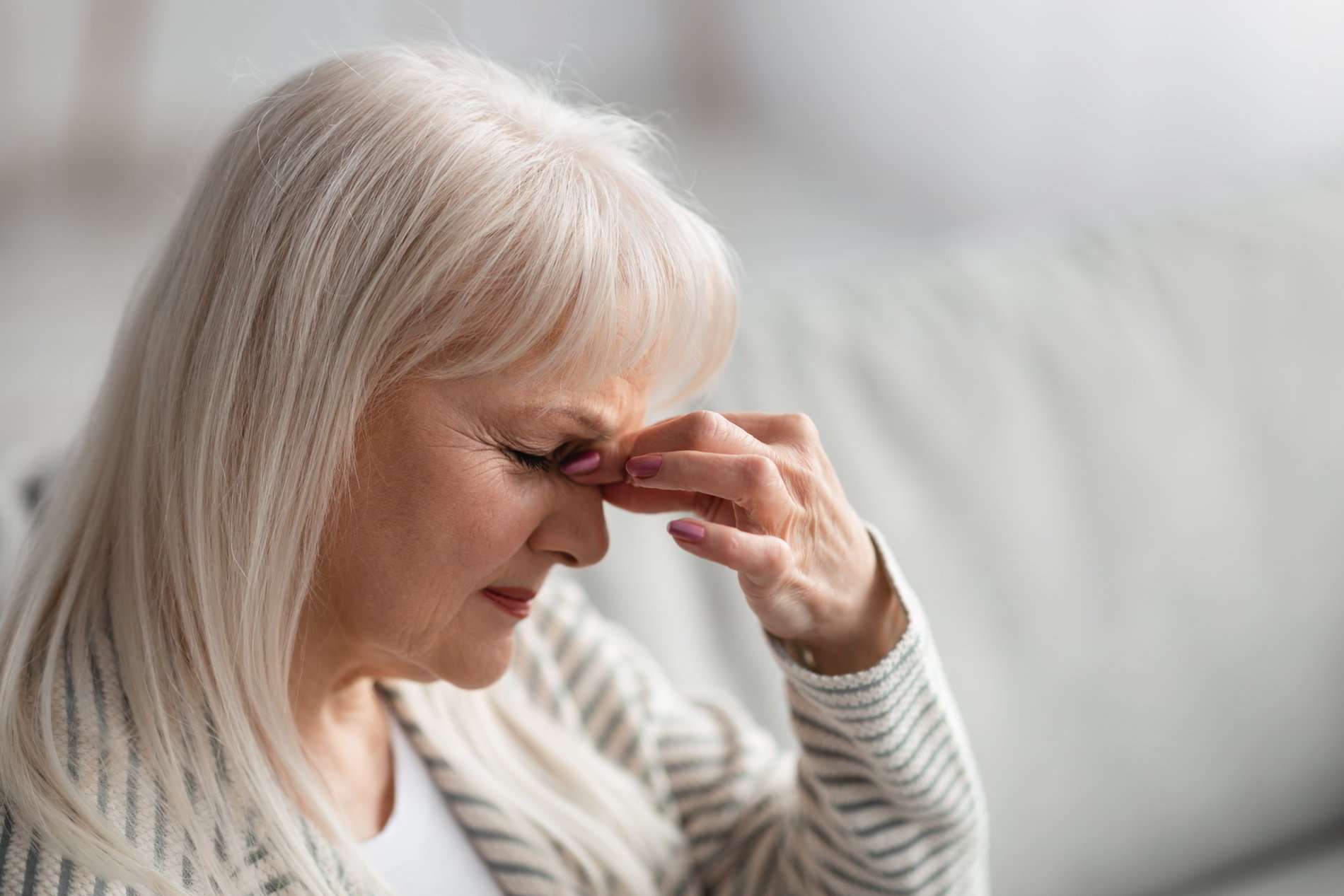 fatigued-upset-older-woman-massaging-nose-bridge-2021-05-25-23-28-29-utc fatigued-upset-older-woman-massaging-nose-bridge-2021-05-25-23-28-29-utc