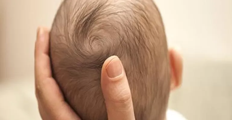 man holding baby head man holding baby head