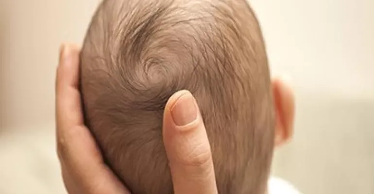 man holding baby head man holding baby head