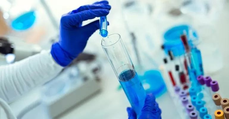 pouring from one test tube to another pouring from one test tube to another