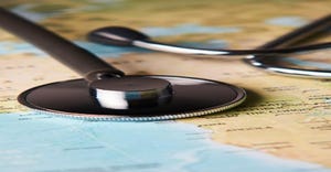 stethoscope on top of map stethoscope on top of map