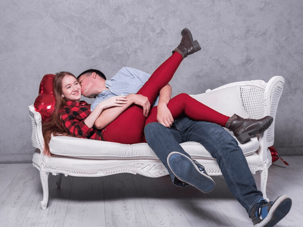 Couple kissing on couch