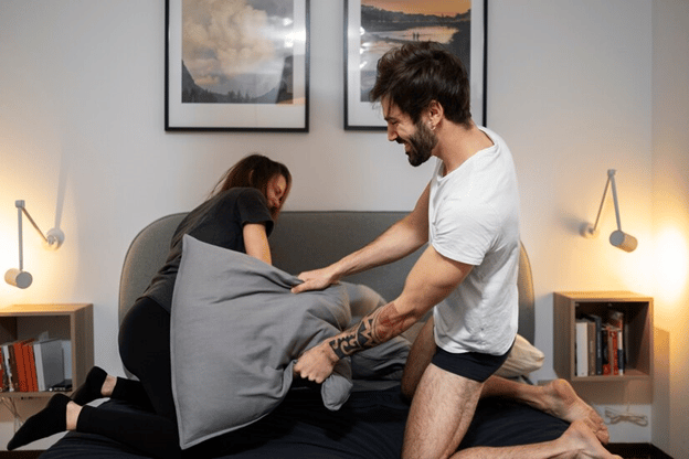 couple pillow fighting