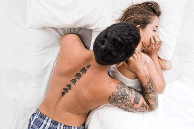 Couple laying in bed