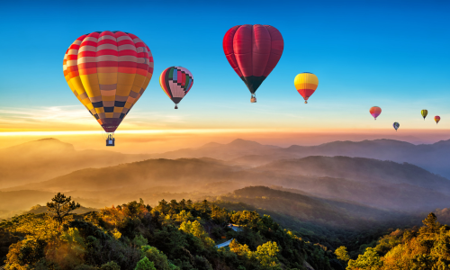 Raisin UK- Hot air balloons over misty valley
