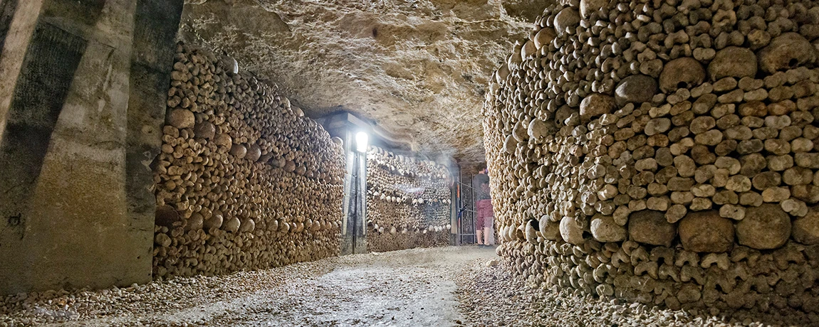 A ghost shape inside the Catacombs and skulls in Paris, France