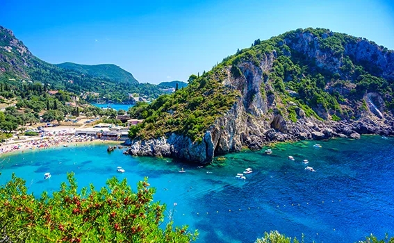 Cliff by clear blue water in Corfu, Greece.