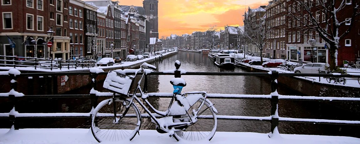 Amsterdam Netherlands, covered in snow at sunset
