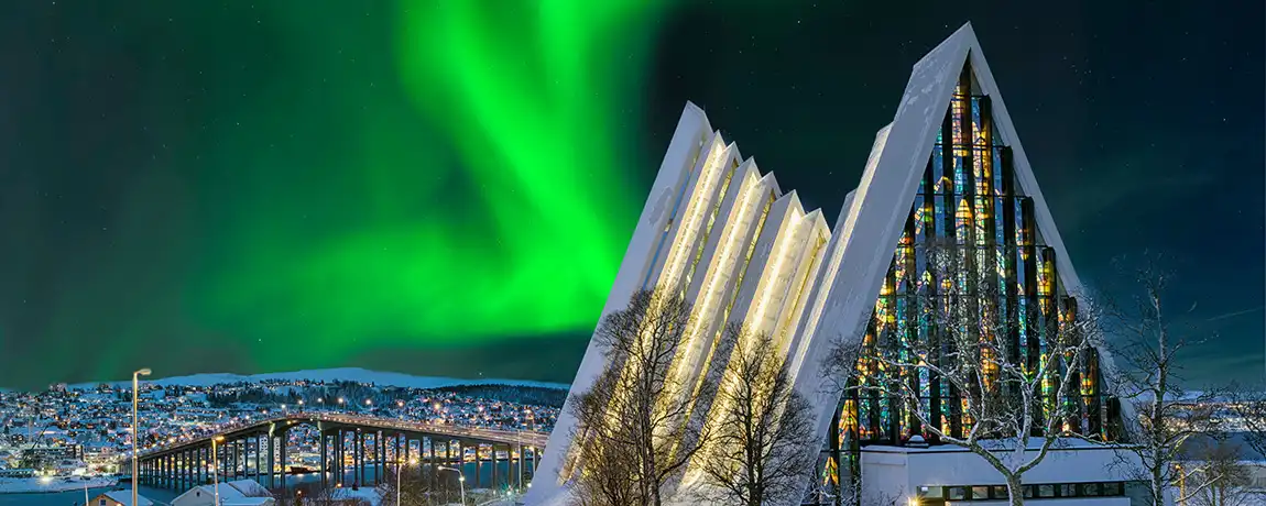 Tromso-northern-lights-behind-church.webp