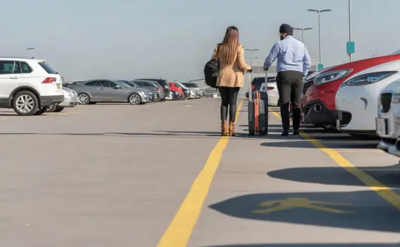 Two people walking in car park