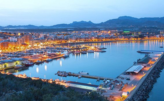Lit up harbour during sunset in Murcia, Spain.