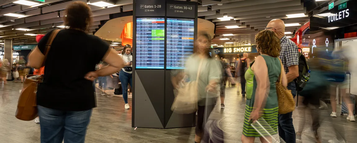 passengers-looking-at-flight-times.webp
