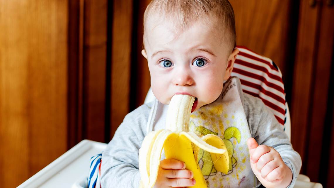 Baby eating banana