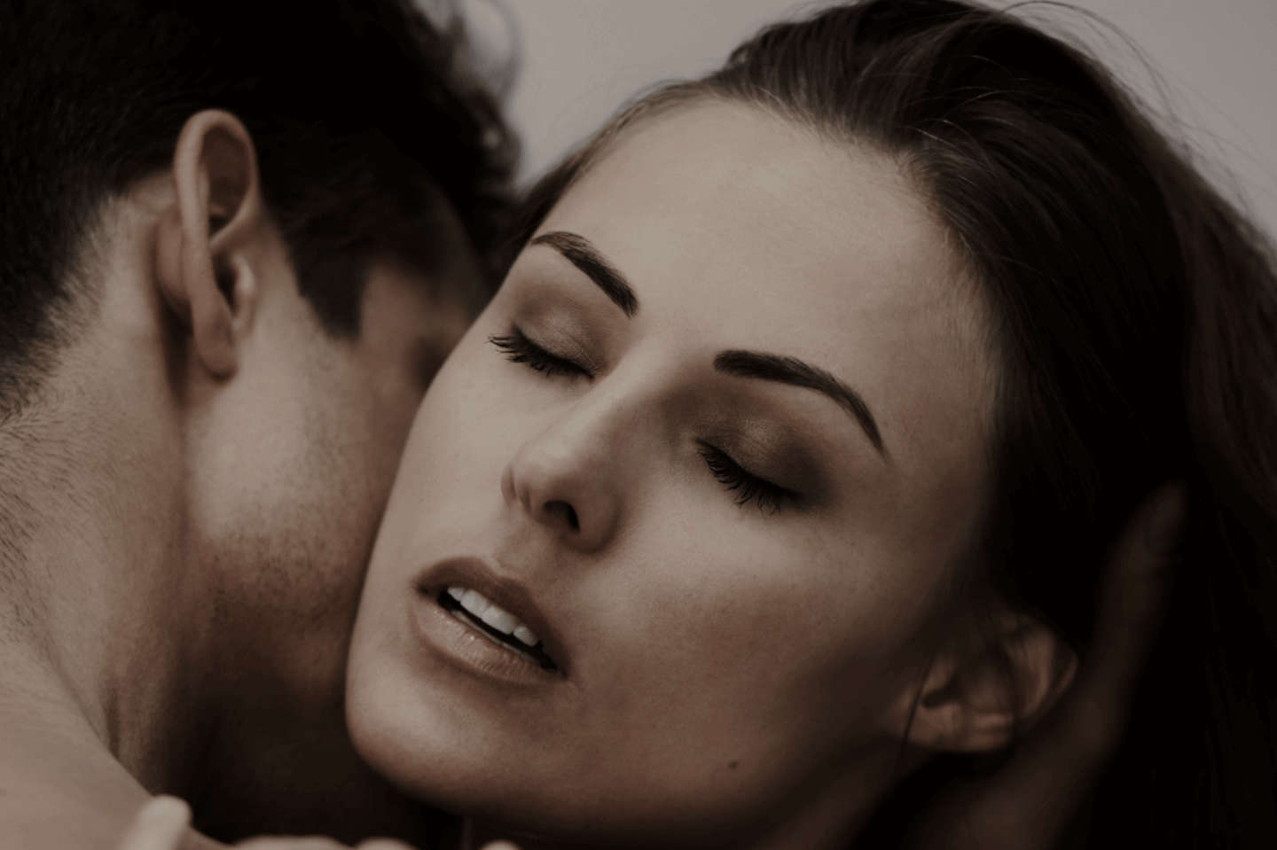 Couple kissing and using lube to spice up their sex life