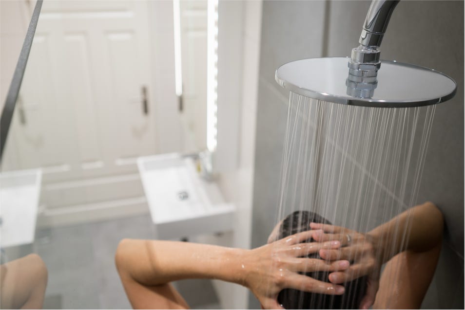 Mujer duchandose en la ducha del baño