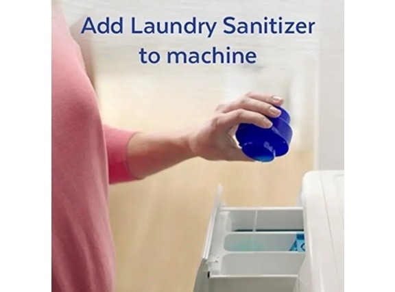The dosing cup being used to dispense Laundry Sanitizer into the fabric softener compartment of the machine.